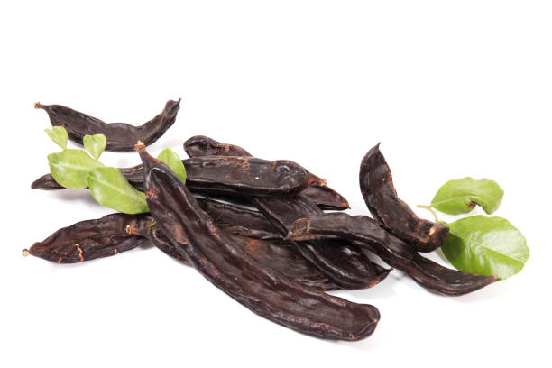 istock carob fruits with leafs 1310323042