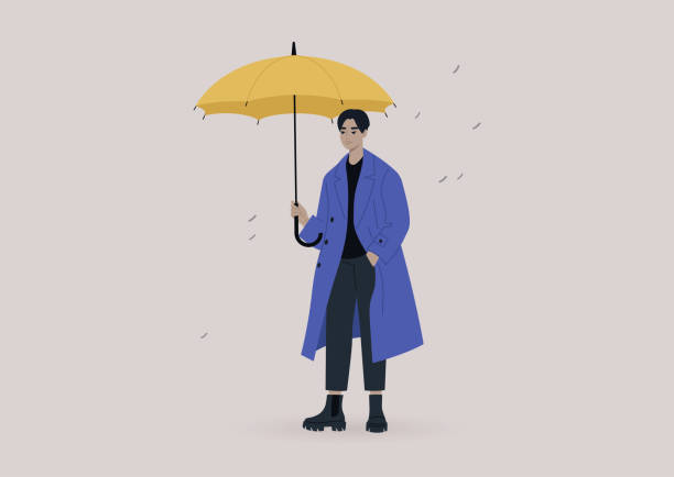 ein junger männlicher asiatischer charakter trägt einen übergroßen mantel und hält einen gelben regenschirm, ein regnerisches wetterkonzept - parasol umbrella asian ethnicity asian culture stock-grafiken, -clipart, -cartoons und -symbole