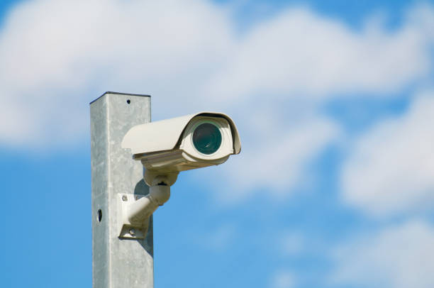 istock Modern CCTV camera on a iron pole against blue sky 1310327798