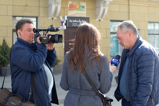 Ukraine Zhytomyr April 1, 2021. A news channel group interviews a man on city street