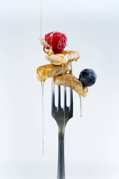 istock pancake on a fork with strawberries on white background 1310333390