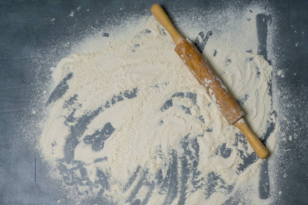 istock Rolling pin and white flour on a dark surface. Top view. 1310333399