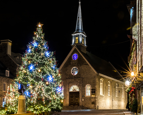 Church lit at night and Christmas tree in Old Quebec