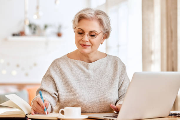 istock Elderly female freelancer working at laptop 1310337745