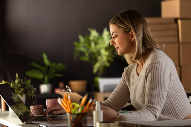 istock Young businesswoman entering data on laptop while working at the office 1310339880