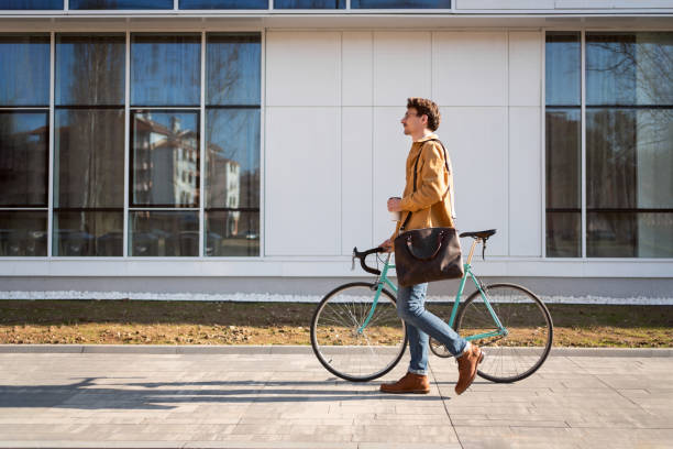 istock Side view of a handsome young man going to work with his bicycle 1310340893