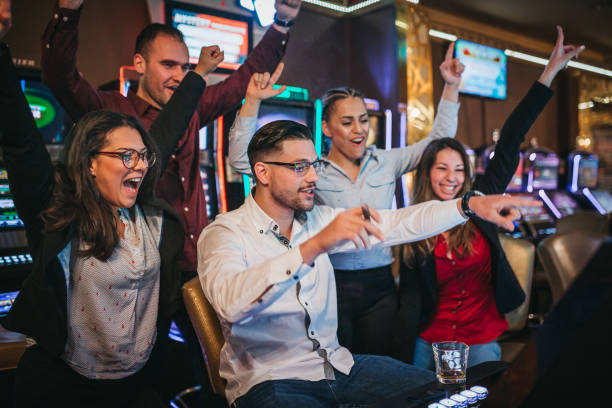 istock Friends gambling on slot machines 1310346112