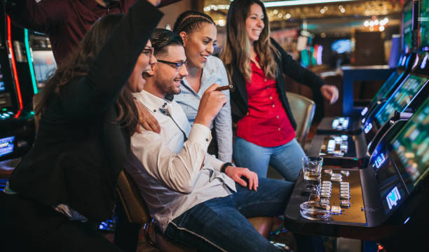istock Friends gambling on slot machines 1310346257