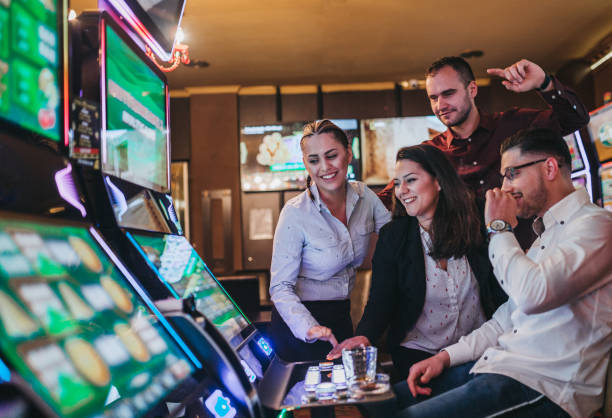 istock Friends gambling on slot machines 1310346259