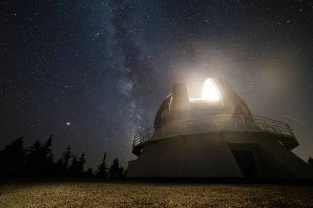 Photo of light coming from the top of an observatory