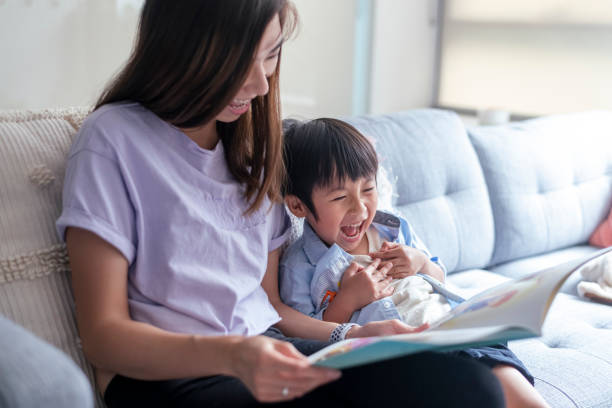 istock Adoring mom reading book with her toddler son at home 1310351504