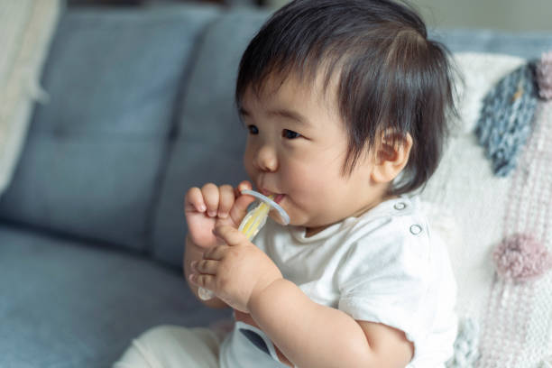 istock Cute baby sucking on teething toy 1310351510