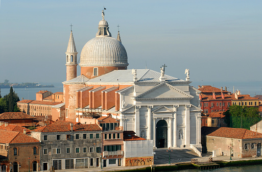 A beautiful panoramic aerial overview of Venice Italy's architectural splendor, featuring a glistening cathedral dome surrounded by water.