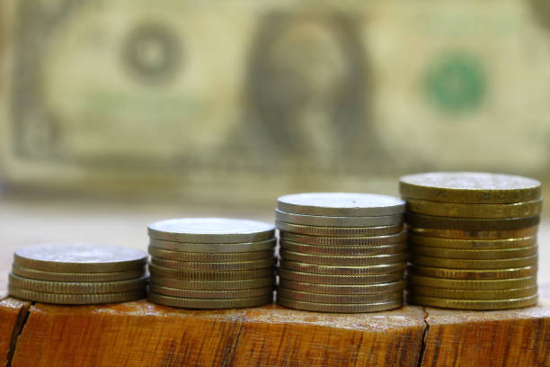 istock Stacking coins on the table Business growth for saving money and financial concept 1310356721