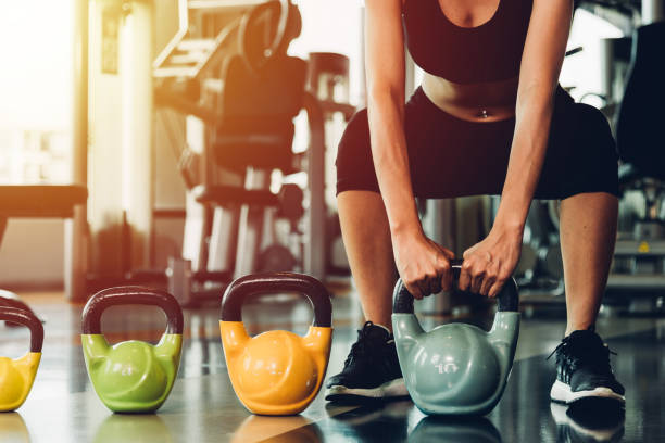 istock Beautiful woman using dumbbell weights workout 1310358613