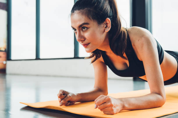 istock Beautiful woman exercise workout with planking on mat 1310358658