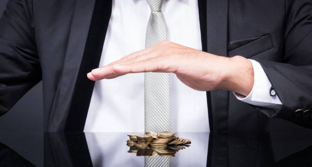 istock Businessman Hands Protecting Gold Money 1310358677