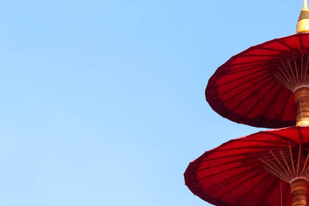 istock Red umbrella on bright blue sky and copy space 1310360361