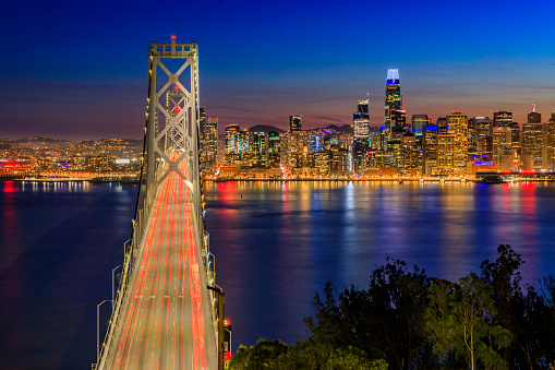 Bay Bridge light trails and downtown San Francisco from Treasure Island, sunset