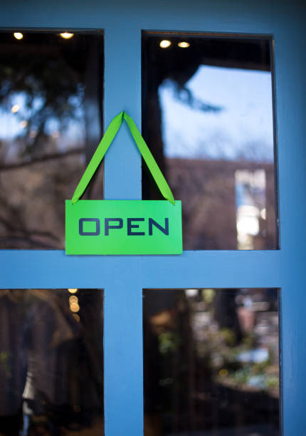 istock Green Open Sign on Turquoise Door 1310363236