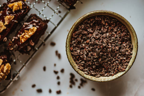 Vegan Chocolate Protein Bars with Walnut Topping Vegan Chocolate Protein Bars with Walnut Topping – homemade version, sugar-free, delicious loaded with cocoa nibs nib stock pictures, royalty-free photos & images