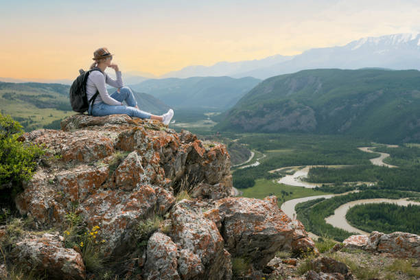 istock Backpacker woman sitting enjoying mountains nature and silence at sunset, thinking. 1310364205