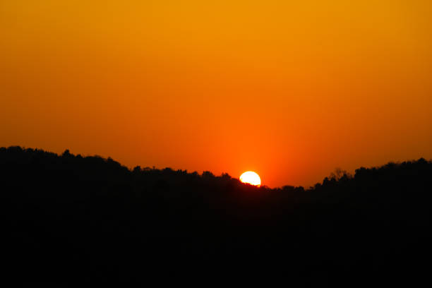 istock Orange Sun down to Sunset over mountain and reflect on river 1310365571