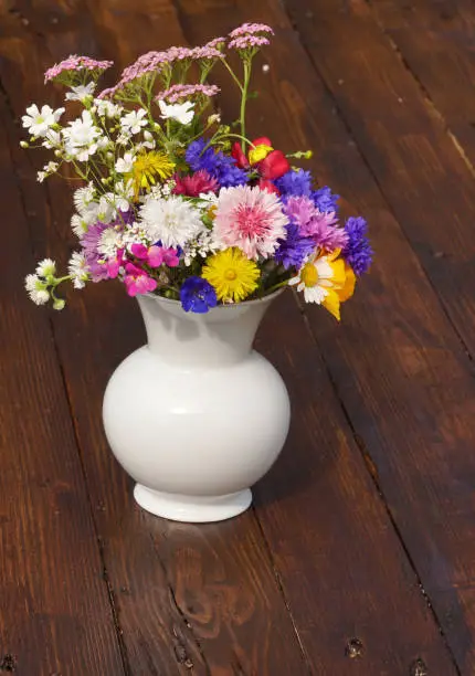Bouquet of summerflowers on wooden table