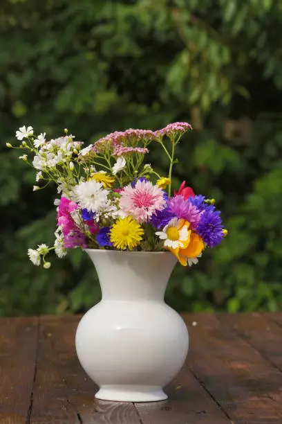 Bouquet of summerflowers on wooden table