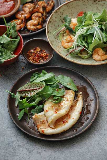 Thai Steam Squid Thai Steam Squid (Pla Muk Neung Manao) with sweet and sour sauces. thai decor stock pictures, royalty-free photos & images