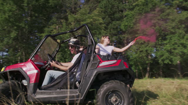Hipster friends On Road Trip Driving In Convertible Car off road in nature and having fun
