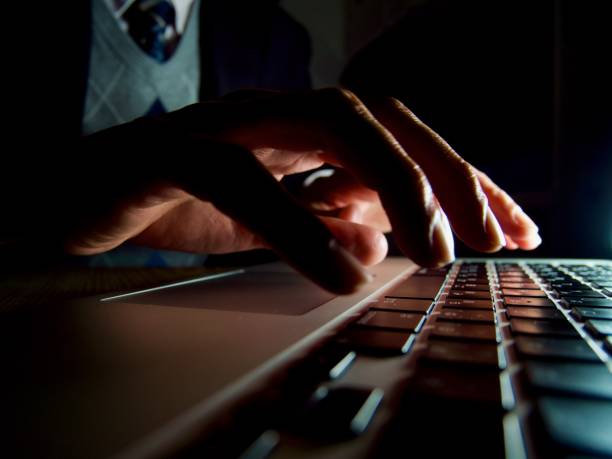 istock Hands typing on notebook keyboard in the dark 1310380027
