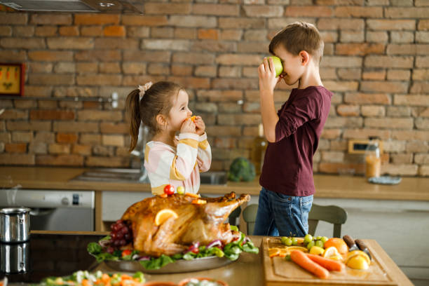 istock Little siblings having fun during Thanksgiving day in the kitchen. 1310382803