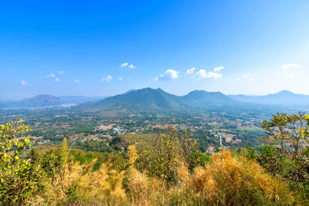 istock Beautiful panoramic view green forest mountain range Phu Thok Park in Loei province,Thailand, blue sky background texture with white clouds 1310383620