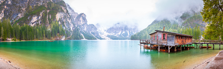 Jetty with boat at Lago di Braies lake in Italy Dolomites. Beautiful Mountains Alps tyrol Landscape. Great nature mountains panorama in the background.
