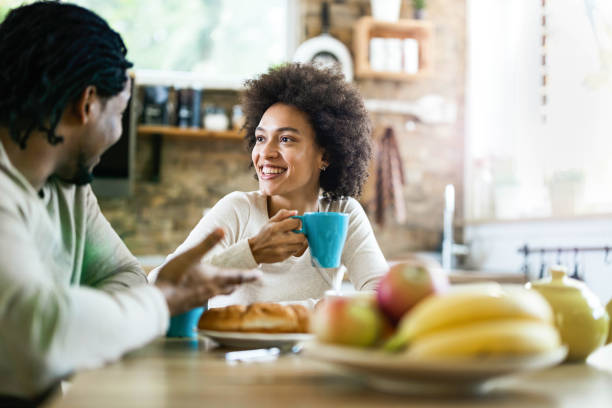 istock Young happy black couple communicating while enjoying in their coffee time. 1310383780