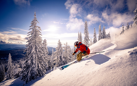 Young skier downhill skiing at Zermatt ski resort with Matterhorn mountain in background, Valais canton, Switzerland, in winter morning. Taken by Sony a7R II, 42 Mpix.