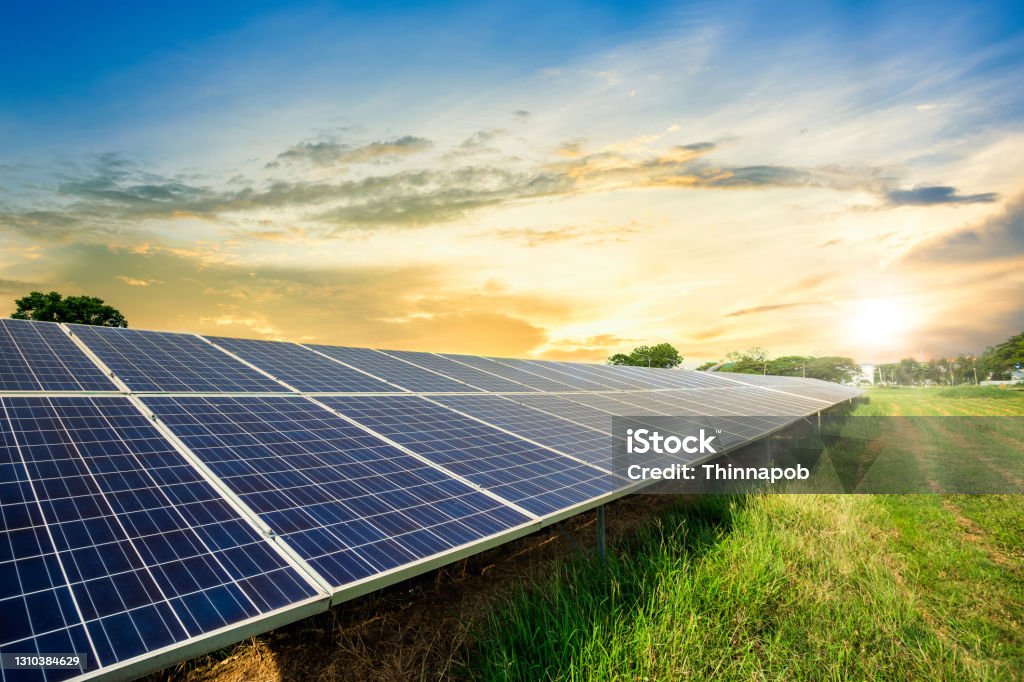 Solar panel cell on dramatic sunset sky background,clean Alternative power energy concept. Solar Panel Stock Photo