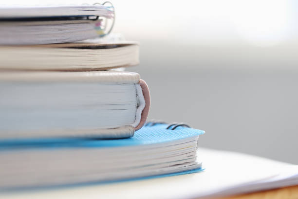 istock Stack of books and notebooks lying on table closeup 1310385550