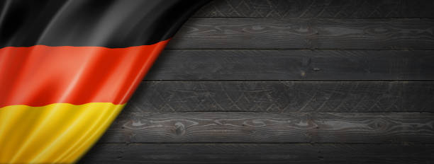 istock German flag on black wood wall banner 1310386480