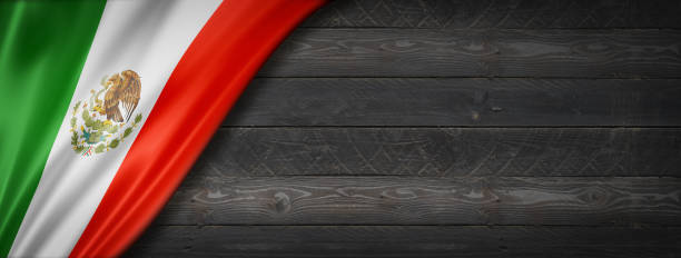 istock Mexican flag on black wood wall banner 1310386604