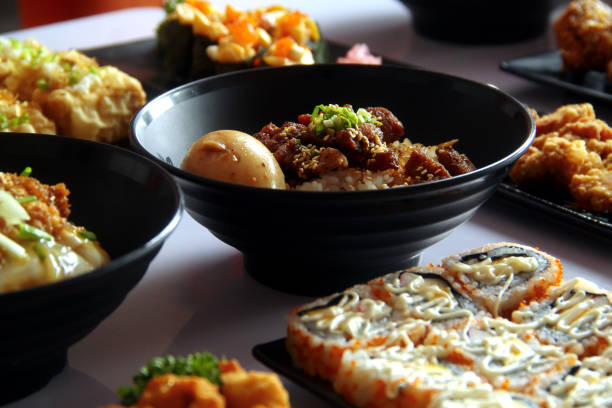 Photo of freshly made assorted Japanese food on a table.
