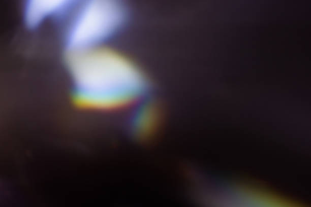 colorful warm rainbow light leaks on black background with dust texture