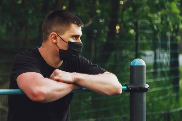 istock Young guy, an athlete stands at crossbar 1310389267