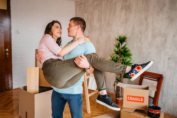 istock Boyfriend lifting happy girlfriend celebrating moving day 1310389535