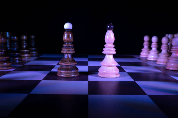 istock Chess figures on a chessboard, bishop. Dark background, neon studio lights 1310389598