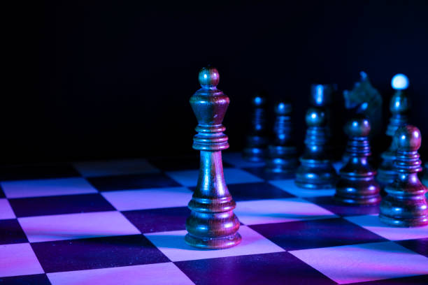 istock King chess figures on a chessboard. Dark background, neon studio lights 1310389623