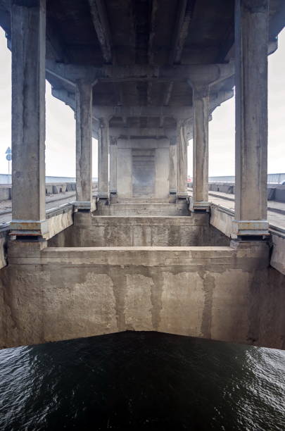 istock Structures and beams under the bridge. Bearing structures of the metro-automobile arch concrete bridge over the river. Metro Bridge across Dnieper River, Kyiv, Ukraine 1310390295