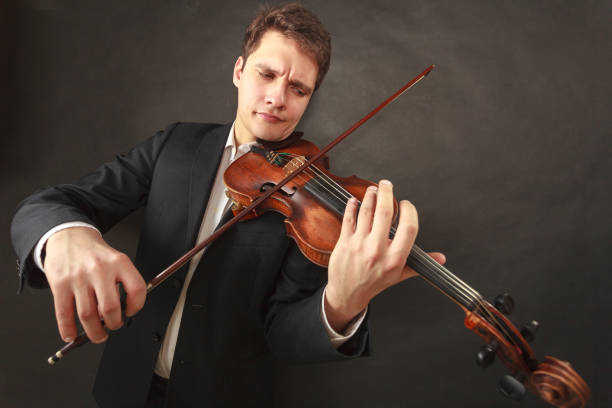 istock Man playing violin showing emotions and expressions 1310392520