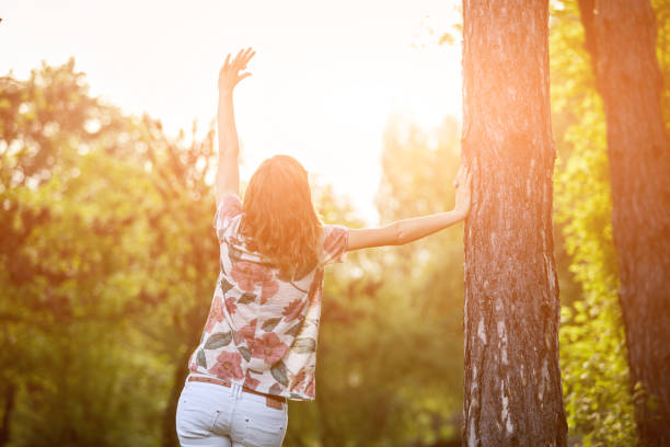 istock Woman in park outdoors feeling happy and powerful. 1310393190